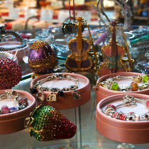 Showcase of elegant bracelets and decorative items in a retail shop display.
