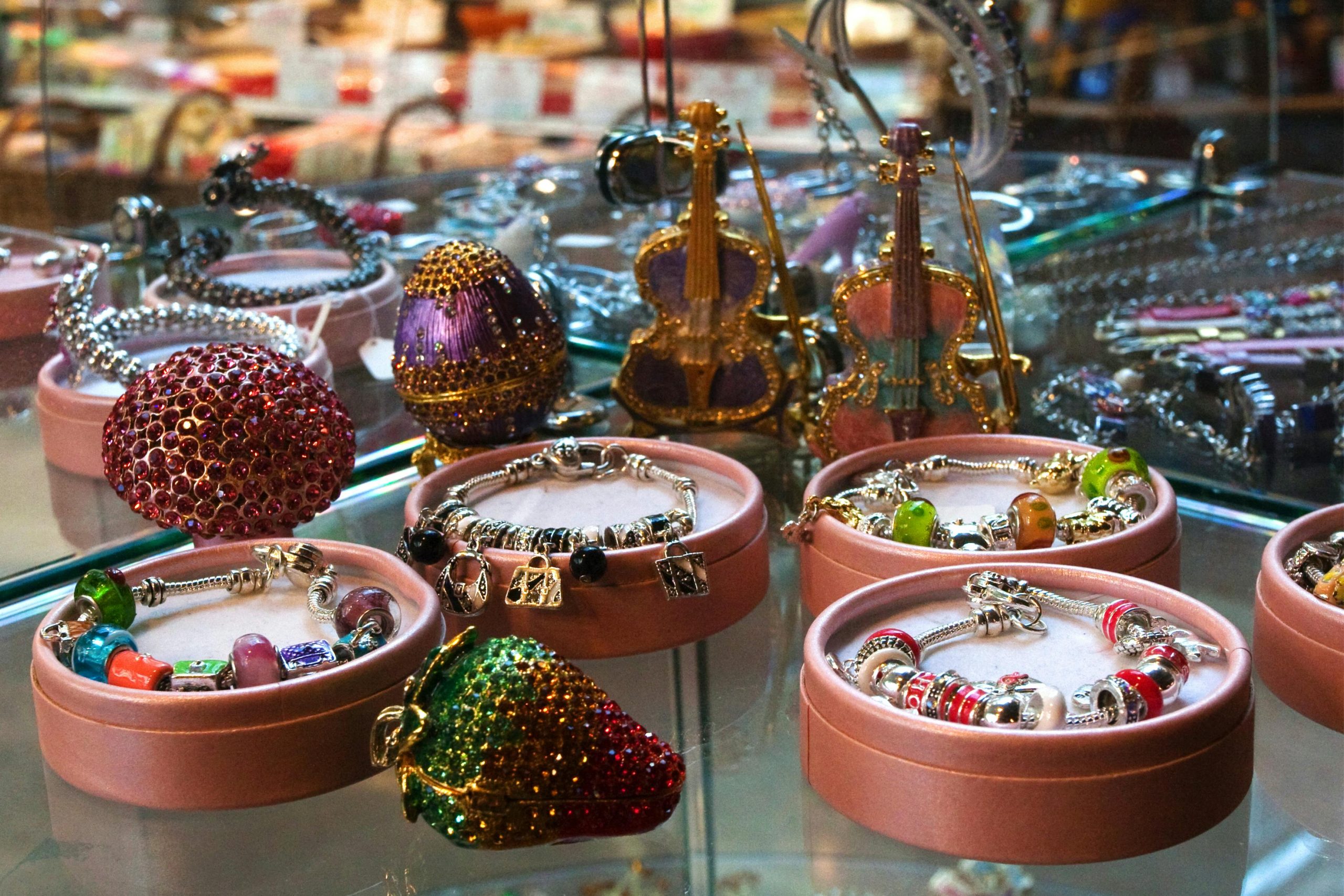 Showcase of elegant bracelets and decorative items in a retail shop display.